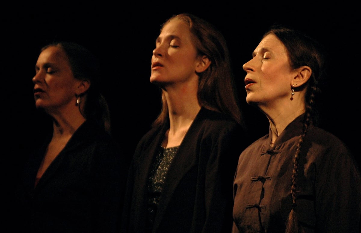 Three artists vocalizing with closed eyes.
