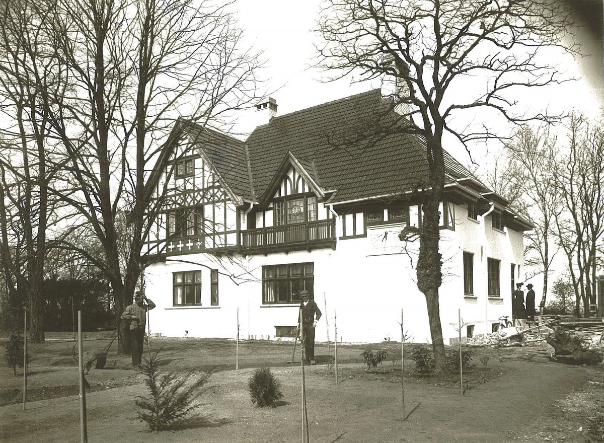 Eldre fotografi av hvitt hus med svarte detaljer