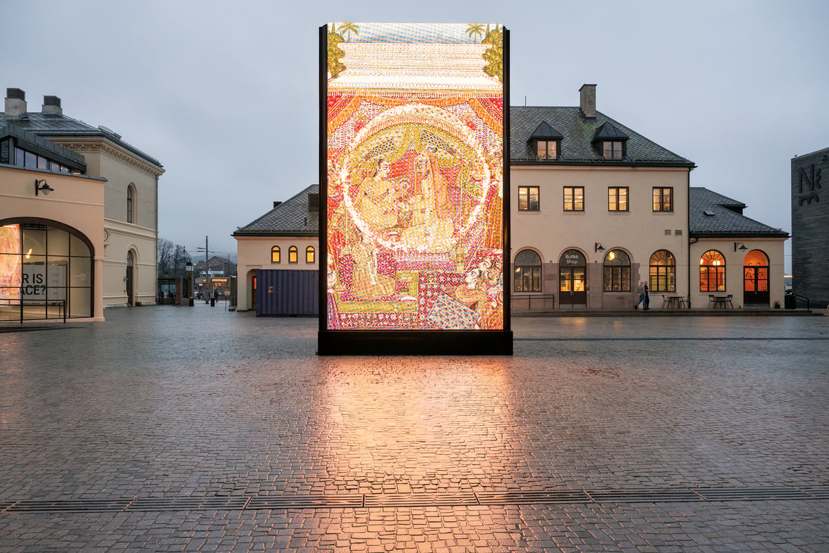 A large scale video installation lights up the square in front of the museum.