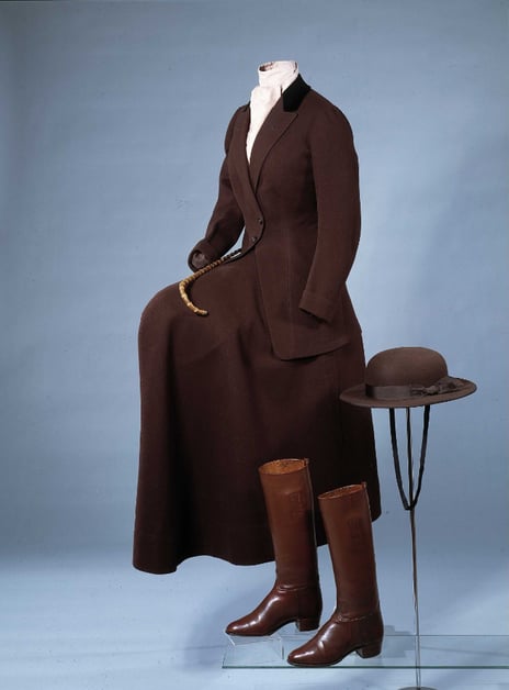 Riding outfit, ca. 1920. John Busvine & Co brown riding outfit: high boots, long jacket and a hat
