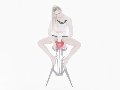 «Permanent Resident», Maria Metsalu, 2026 A person sits on a red, geometrically designed stool in a bright, minimalist studio