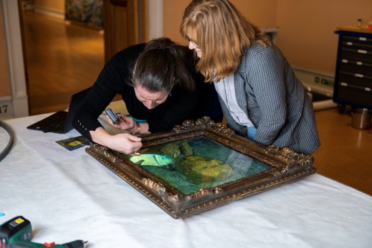 The painting is routinely checked by the conservator before being lent to the Van Gogh Museum in Amsterdam. Conservator checking the painting with a flashlight