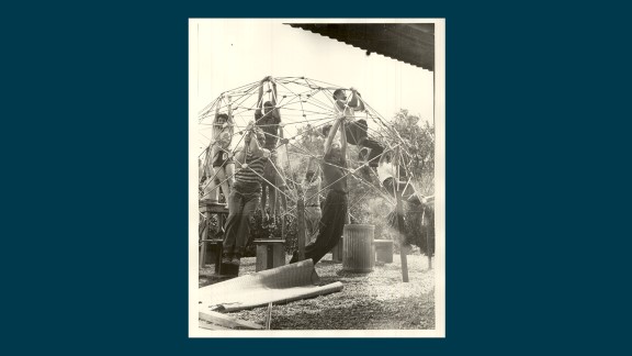 Fotografi av syv studenter ved Black Mountain college sommeren 1949, som henger i en dome konstruert av rør og plast. 