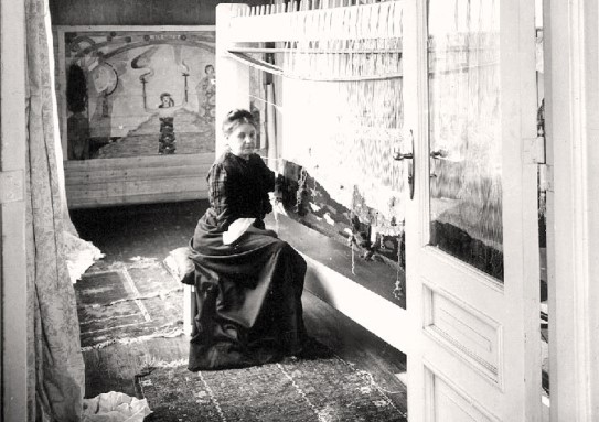Hansen mastered the entire weaving process, from dyeing yarns to preparing cardboard and even transferring patterns to the loom. Woman weaving