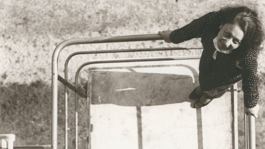 Otti Berger on a balcony at the Bauhaus school. woman on balcony