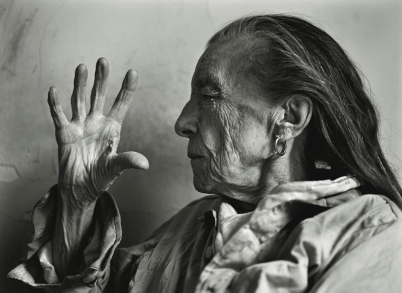 Louise Bourgeois in 1997. Older woman holding her hand up