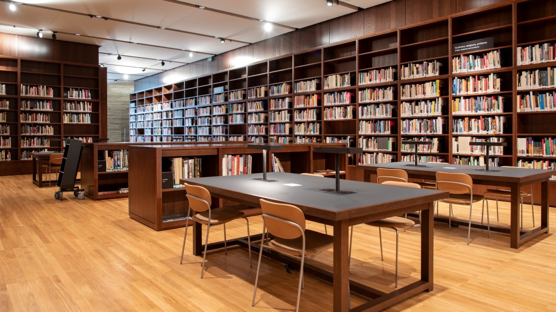 Library shelves with desk and chairs